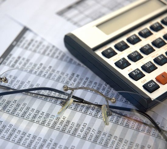 Glasses Beside Calculator - Business Consultant in Australia