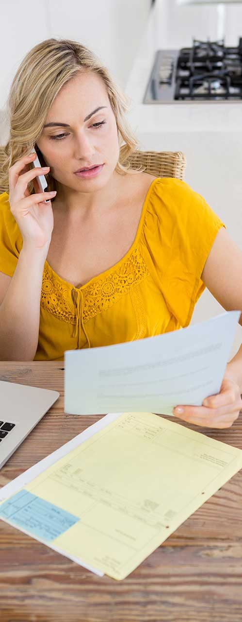 Woman Talking on Mobile Phone While Looking at Bill — Business Consultant in Australia